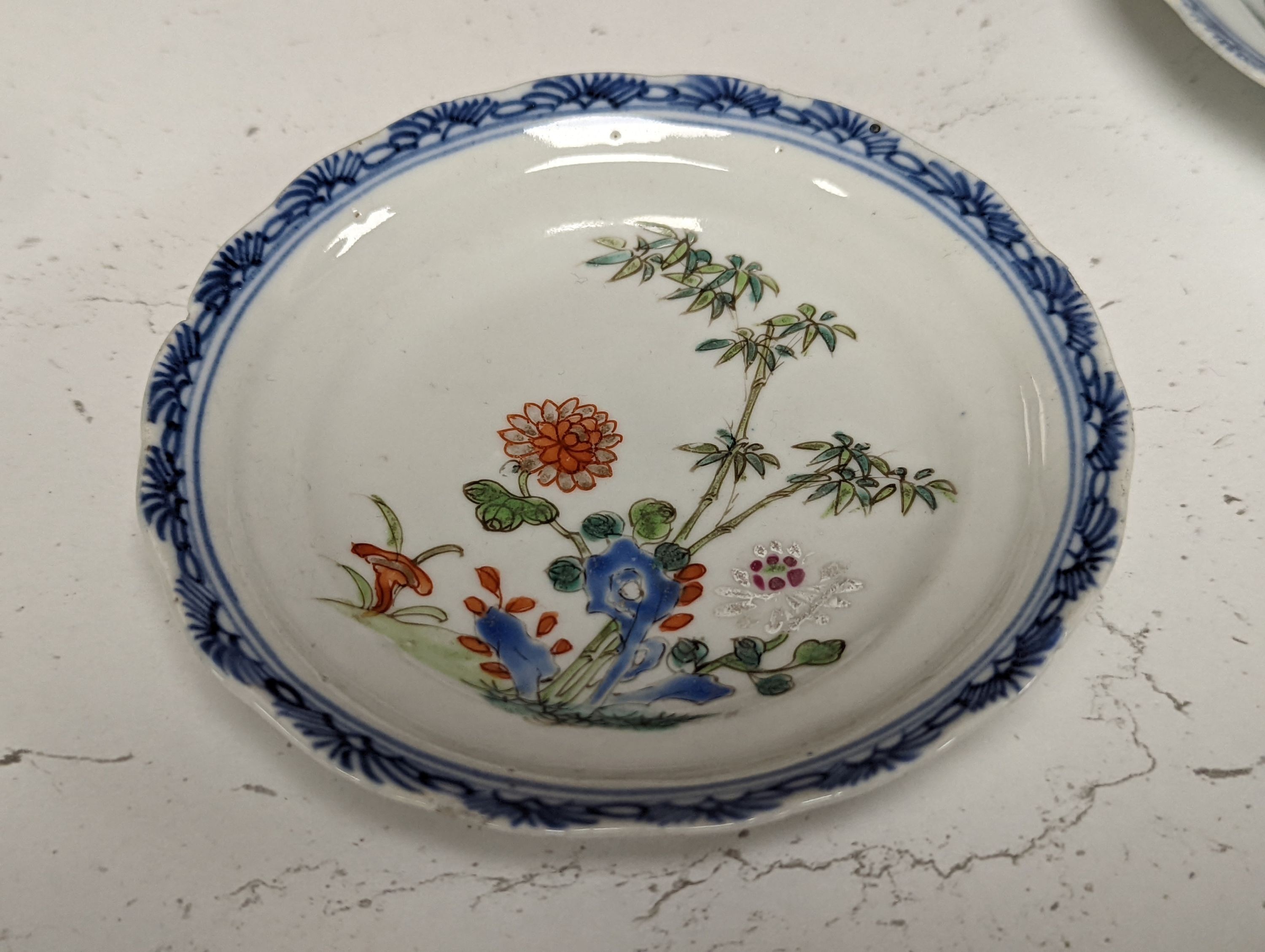 Seven 18th century Chinese saucer dishes, largest 14 cms diameter.